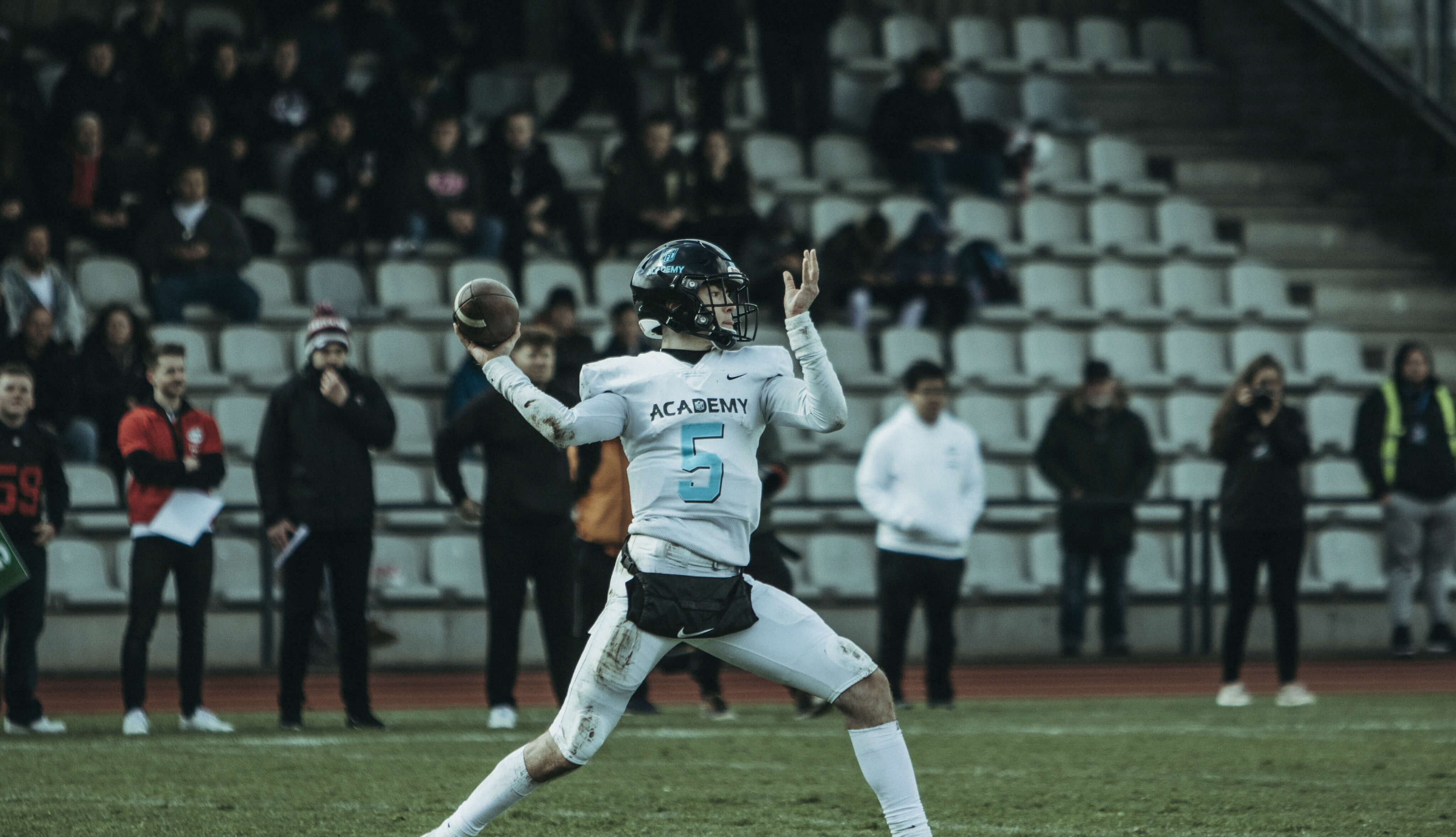 NFL Academy player throwing football